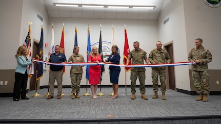 Pictured left to right: Nancy Maloy, NSWC Crane Platform Protection & Countermeasures Technologies Division Manager, Marty Terry, NSWC Crane Countermeasures Assessment Branch Manager, Brigadier General Cathy Eaken, Congresswoman Erin Houchin, Dr. Angela Lewis (SES), Technical Director, NSWC Crane, COL Russell “Bubba” Strange, COL Daniel Bell, and Command Sgt Maj. Brad Simmons at the ribbon cutting for the nation’s first ground-based Sled Track Facility at Camp Atterbury in Indiana.