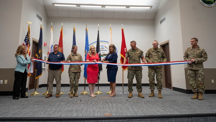 Pictured left to right: Nancy Maloy, NSWC Crane Platform Protection & Countermeasures Technologies Division Manager, Marty Terry, NSWC Crane Countermeasures Assessment Branch Manager, Brigadier General Cathy Eaken, Congresswoman Erin Houchin, Dr. Angela Lewis (SES), Technical Director, NSWC Crane, COL Russell “Bubba” Strange, COL Daniel Bell, and Command Sgt Maj. Brad Simmons at the ribbon cutting for the nation’s first ground-based Sled Track Facility at Camp Atterbury in Indiana.