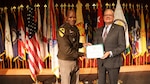 IMCOM Commanding General Lt. Gen. James Smith presents Randy Robinson, IMCOM Executive Deputy to the Commanding General, with his retirement certificate during Robinson's retirement ceremony Aug. 5 at the Fort Sam Houston Theater. Robinson retired after a distinguished 39-year career in the federal civil service.