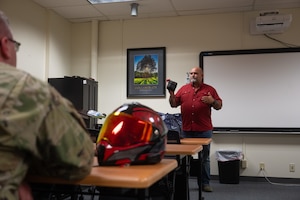 Mark Dumdie, 17th Training Wing Safety motorcycle safety program manager, discusses the importance of individual first aid kits during a motorcycle safety meeting at Goodfellow Air Force Base, Texas, Aug. 14, 2026. Safety helps protect the Department of War’s most valuable assets by mitigating risks and promoting a safe operational environment that keeps service members healthy, trained and ready to accomplish the mission. (U.S. Air Force photo by Senior Airman Brian Lummus)