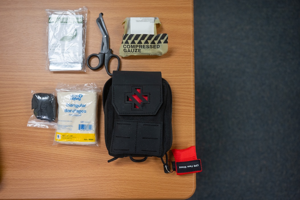 An individual first aid kit is displayed during a motorcycle safety meeting at Goodfellow Air Force Base, Texas, Aug. 14, 2026. IFAKs were provided by 17th Training Wing Safety to help service members stay safe, ready and prepared to handle medical emergencies that occur during motorcycle mishaps. (U.S. Air Force Photo by Senior Airman Brian Lummus)