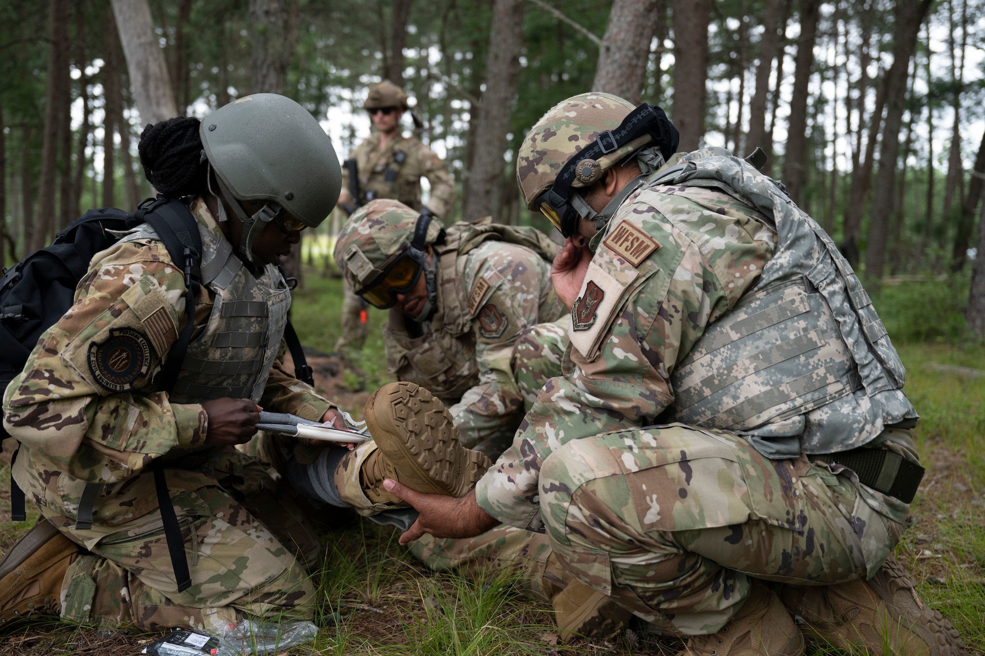 U.S. Airmen from the 87th Civil Engineer Squadron and 514th CES practice tactical combat casualty care on a simulated casualty during Prime Base Engineer Emergency Force Day at Joint Base McGuire-Dix-Lakehurst, N.J., July 30, 2026.