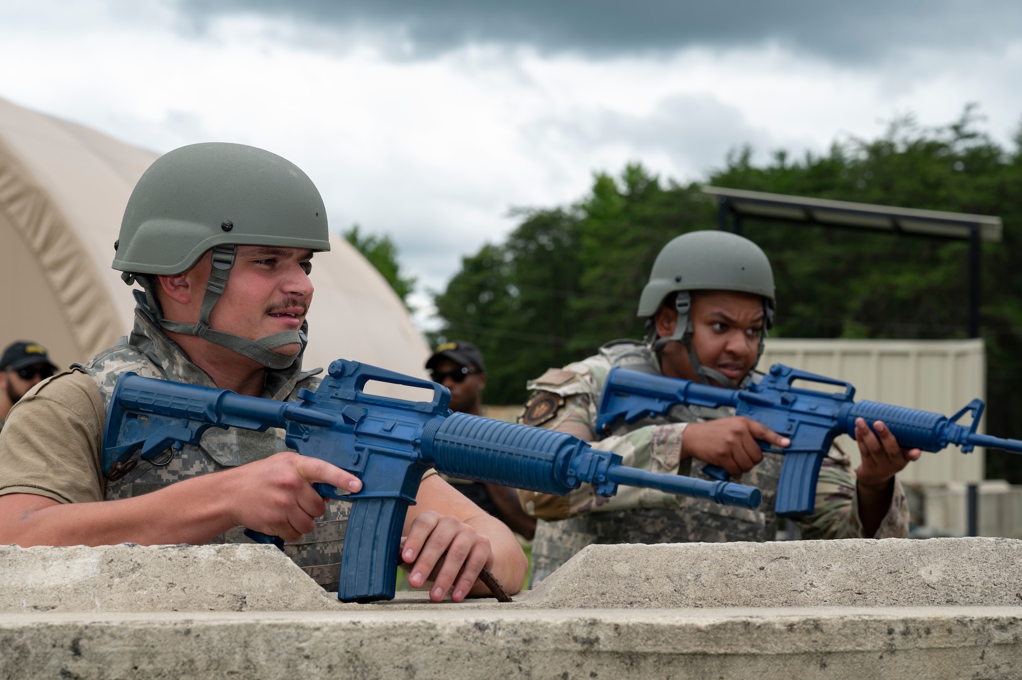 U.S. Air Force Airman 1st Class Trenton Klaus, left, 87th Civil Engineer Squadron heating, ventilating, and air-conditioning apprentice, and Senior Airman Tyriek Holoman, 87th Civil Engineer Squadron electrical systems apprentice, occupy a defensive fighting position during Prime Base Engineer Emergency Force Day at Joint Base McGuire-Dix-Lakehurst, N.J., July 30, 2026.