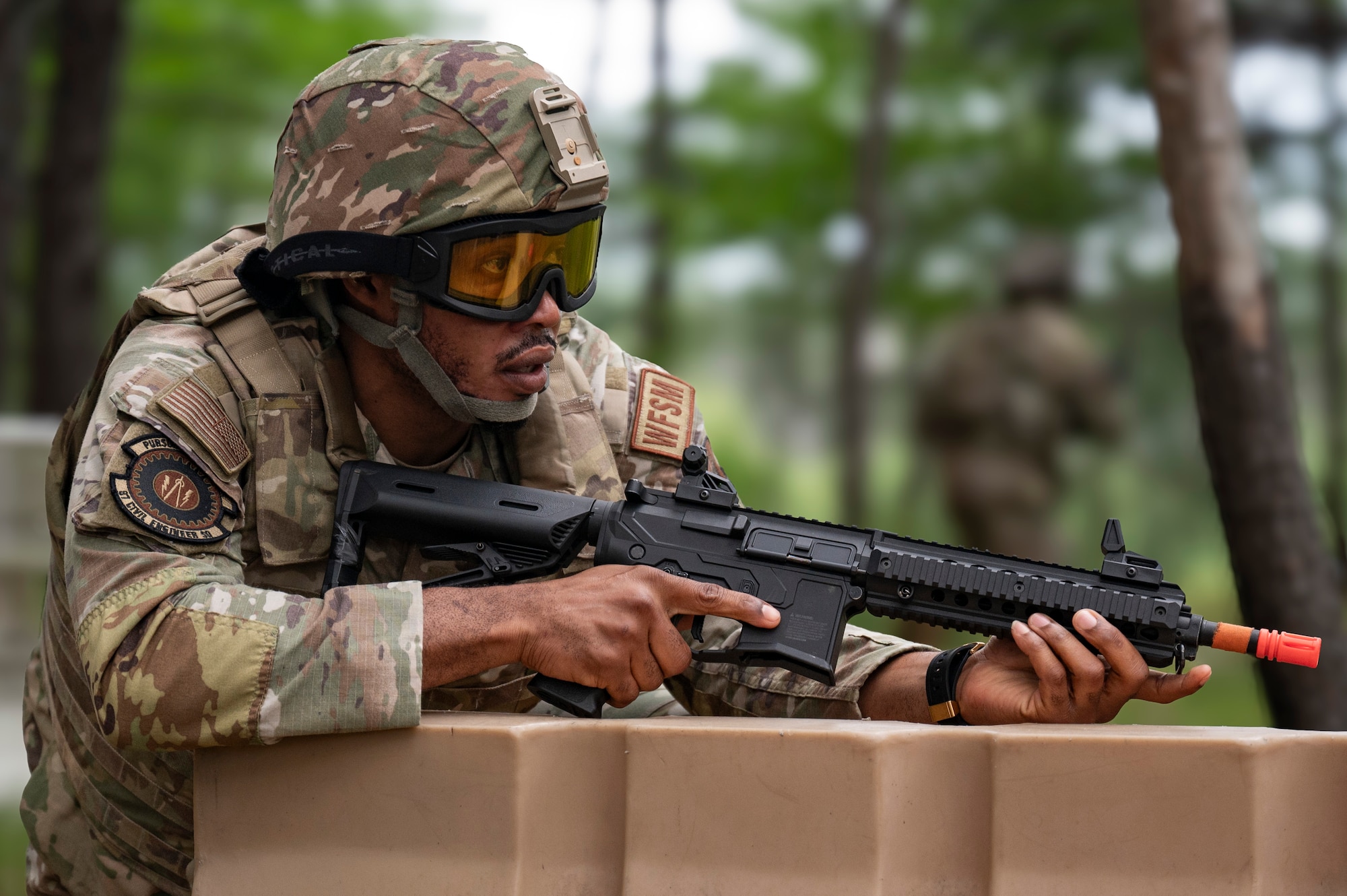 U.S. Air Force Senior Airman Andre McFarlane, 439th Civil Engineer Squadron, Westover Air Reserve Base, MA, Water and Fuel Systems Maintenance journeyman, looks for simulated opposing forces during Prime Base Engineer Emergency Force Day at Joint Base McGuire-Dix-Lakehurst, N.J., July 30, 2026.