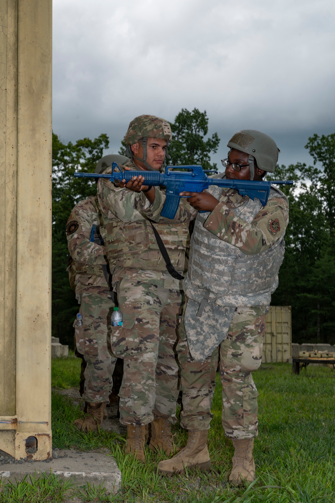U.S. Air Force Airman 1st Class Halimat Kadri, right, 87th Civil Engineer Squadron water and fuel systems maintenance apprentice, aims her training weapon around a corner as other Airmen wait their turn to practice the urban warfare scenario during Prime Base Engineer Emergency Force Day at Joint Base McGuire-Dix-Lakehurst, N.J., July 30, 2026.