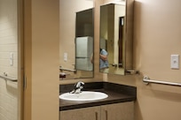 A vanity with sink and mirrors.