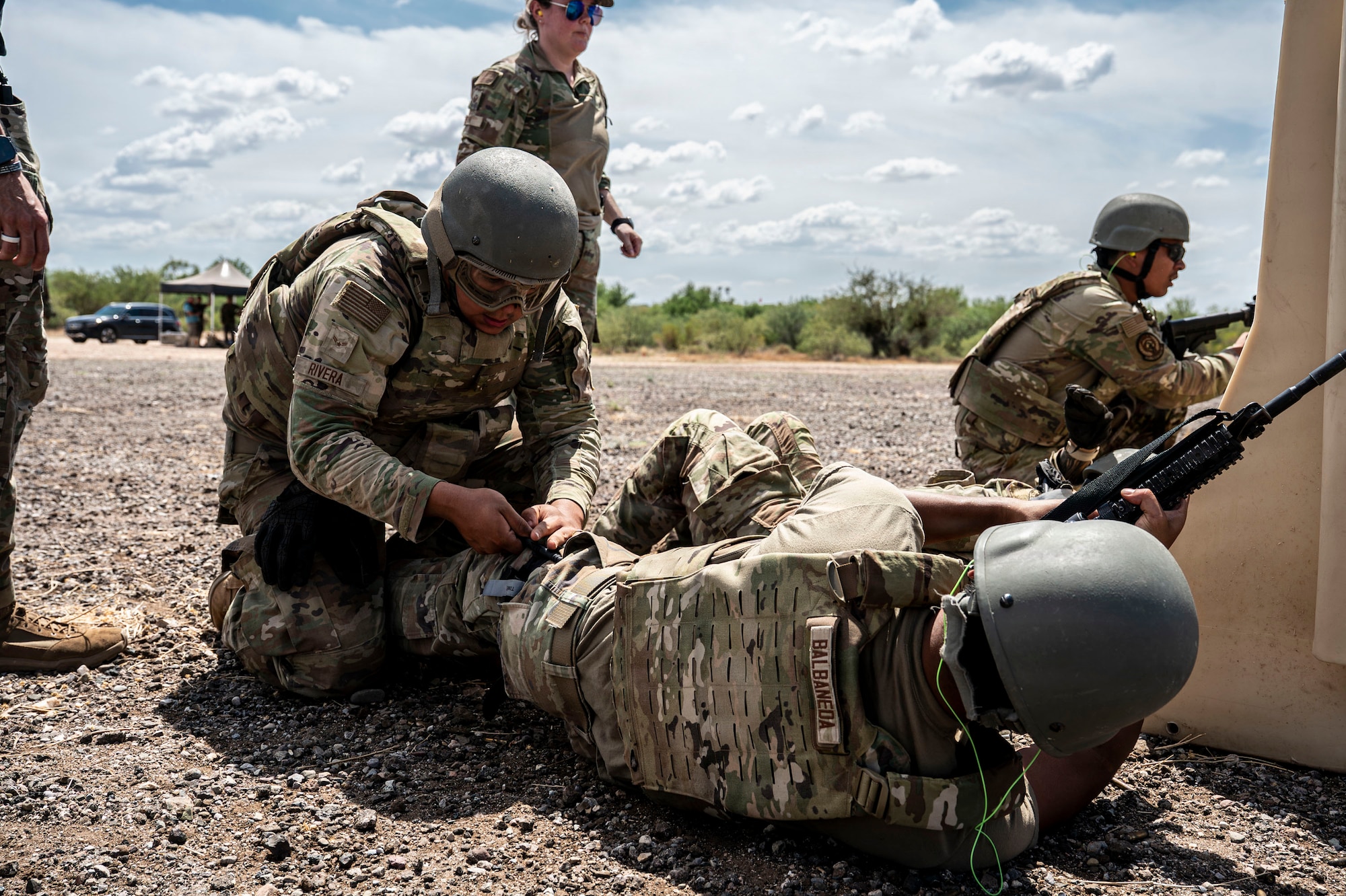 U.S. Airmen participating in an Advanced Ready Training Core course move with weapons to rescue a simulated casualty at Davis-Monthan Air Force Base, Arizona, Aug. 6, 2026. The scenario combined tactical movement and casualty evacuation procedures to strengthen expeditionary readiness and develop mission-essential warfighting skills. (U.S. Air Force photo by Airman 1st Class Samantha Melecio)