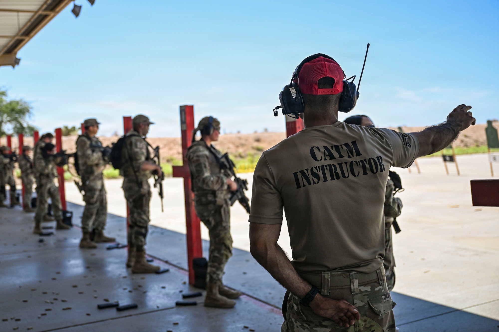 U.S. Airmen participating in an Advanced Ready Training Core course move with weapons to rescue a simulated casualty at Davis-Monthan Air Force Base, Arizona, Aug. 6, 2026. The scenario combined tactical movement and casualty evacuation procedures to strengthen expeditionary readiness and develop mission-essential warfighting skills. (U.S. Air Force photo by Airman 1st Class Samantha Melecio)