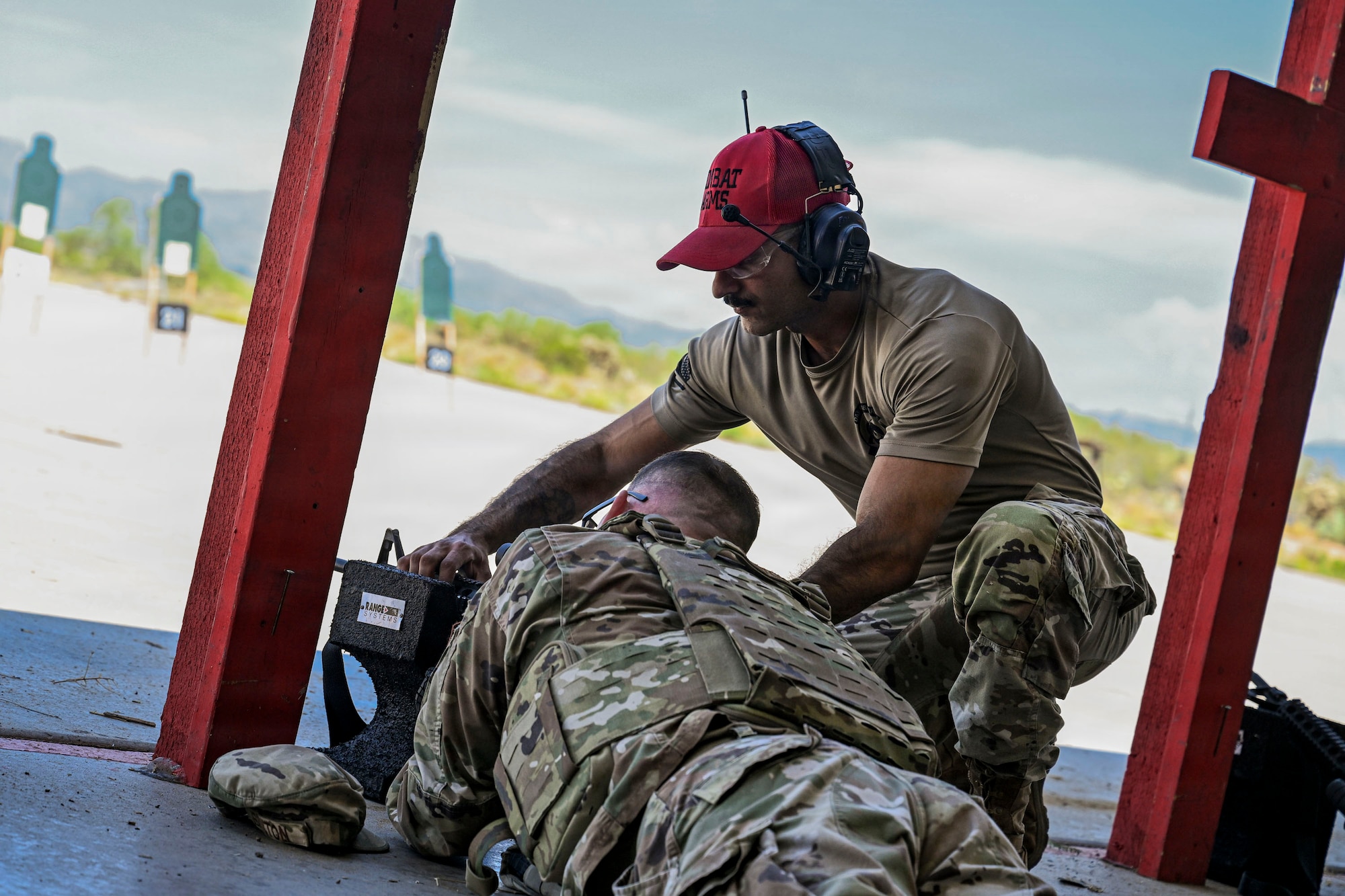 U.S. Airmen participating in an Advanced Ready Training Core course move with weapons to rescue a simulated casualty at Davis-Monthan Air Force Base, Arizona, Aug. 6, 2026. The scenario combined tactical movement and casualty evacuation procedures to strengthen expeditionary readiness and develop mission-essential warfighting skills. (U.S. Air Force photo by Airman 1st Class Samantha Melecio)