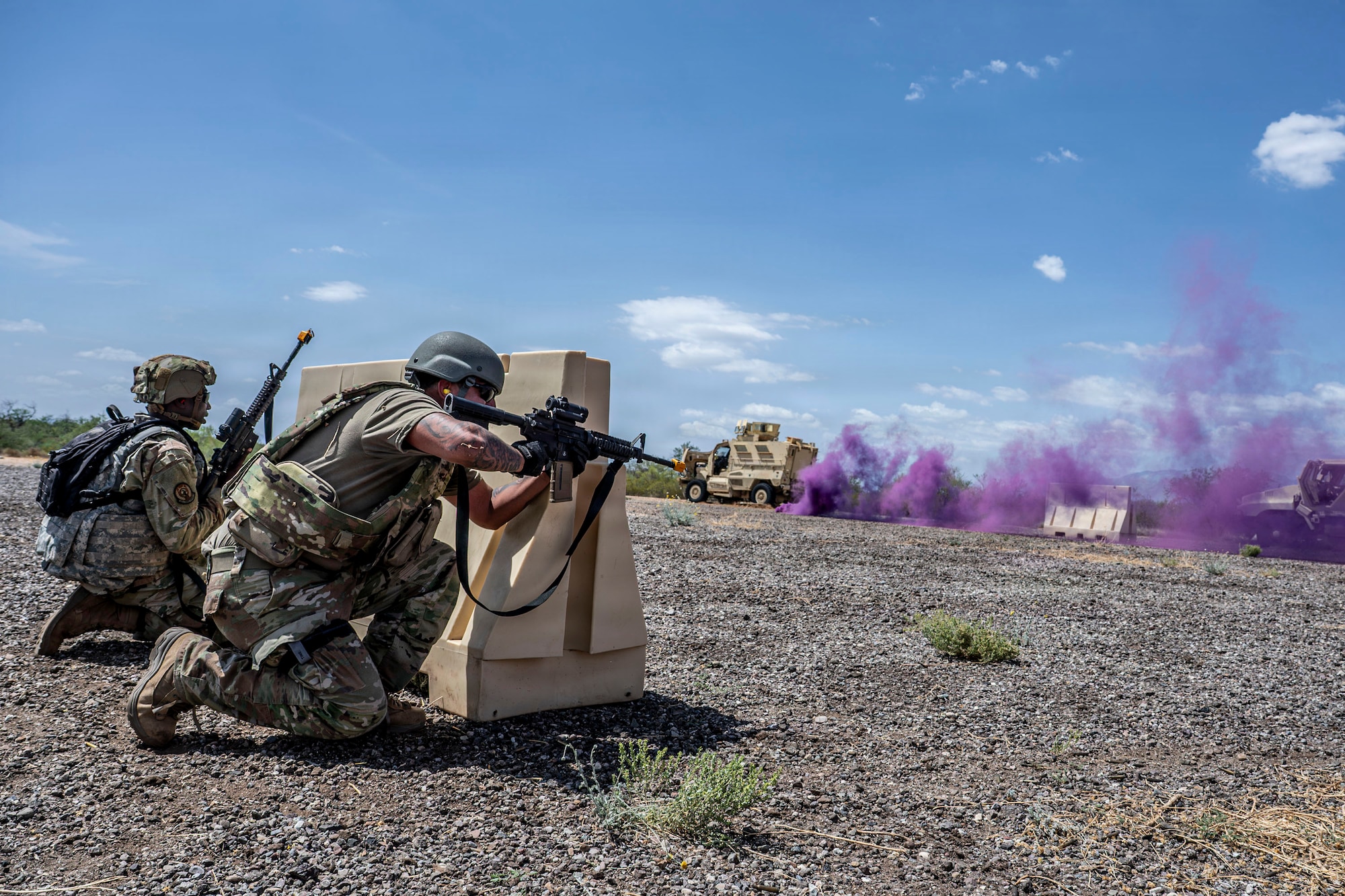 U.S. Airmen participating in an Advanced Ready Training Core course move with weapons to rescue a simulated casualty at Davis-Monthan Air Force Base, Arizona, Aug. 6, 2026. The scenario combined tactical movement and casualty evacuation procedures to strengthen expeditionary readiness and develop mission-essential warfighting skills. (U.S. Air Force photo by Airman 1st Class Samantha Melecio)