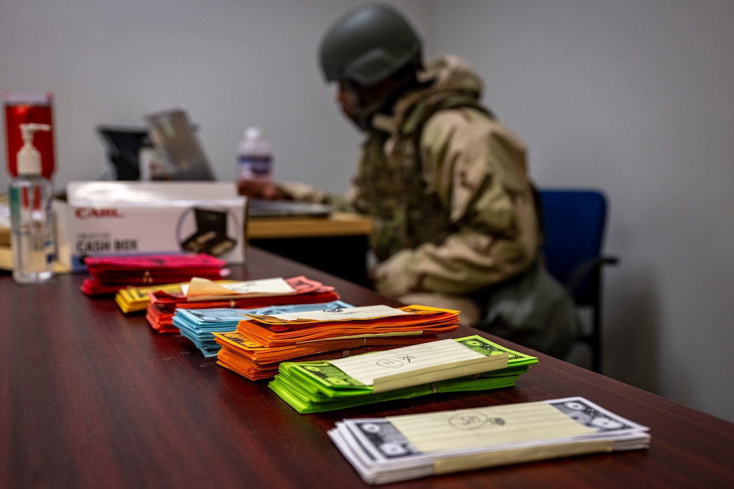 Simulated currency is on a table during exercise