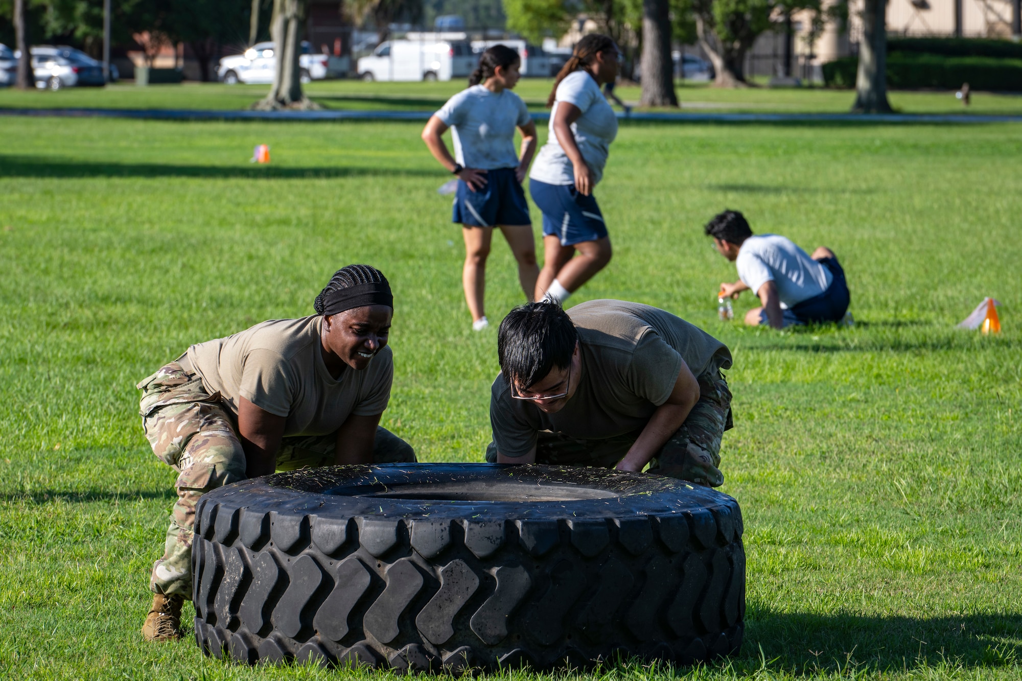 Airmen flip a tire during exercise