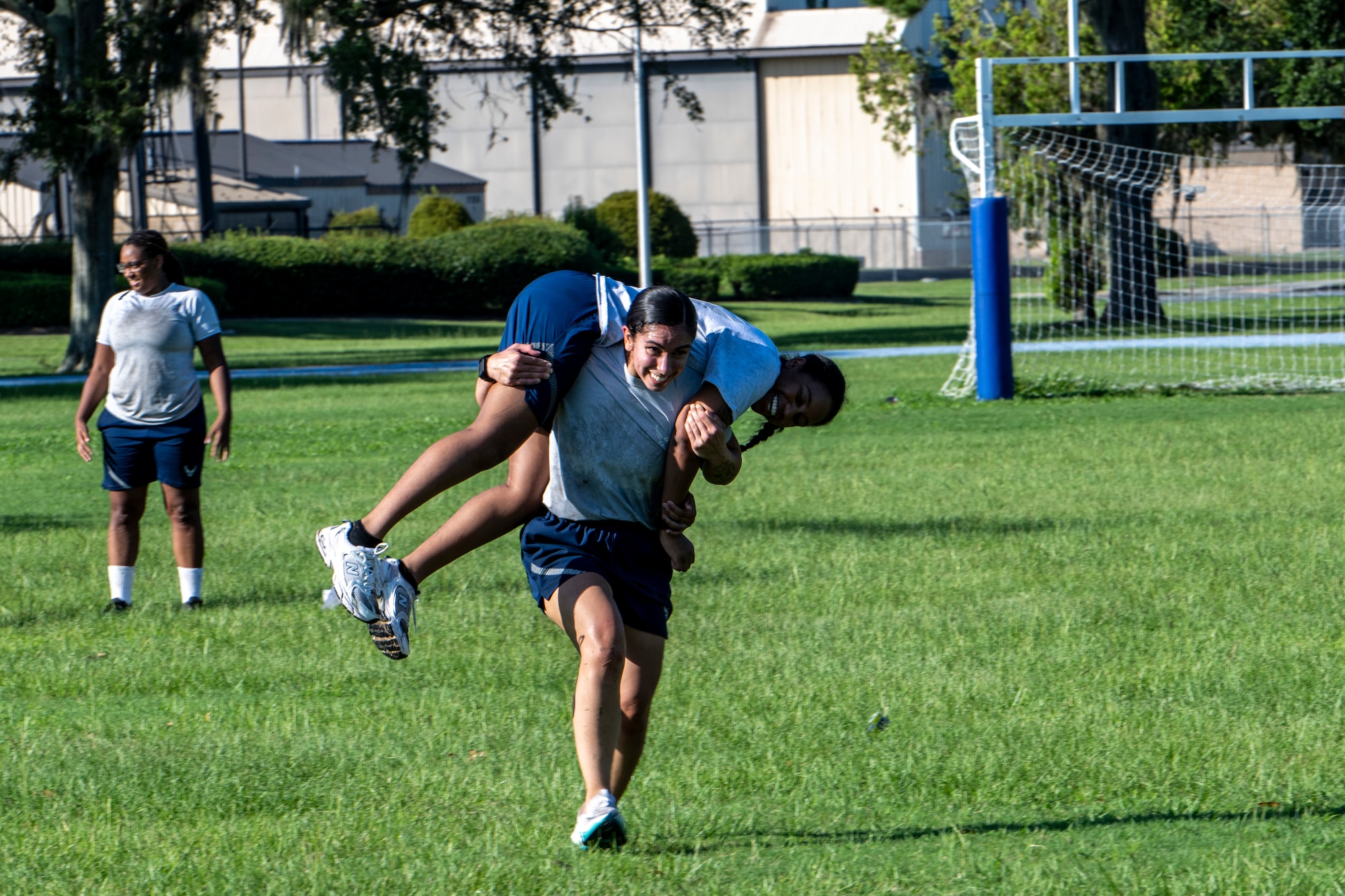 Airman perform a cross body carry during exercise