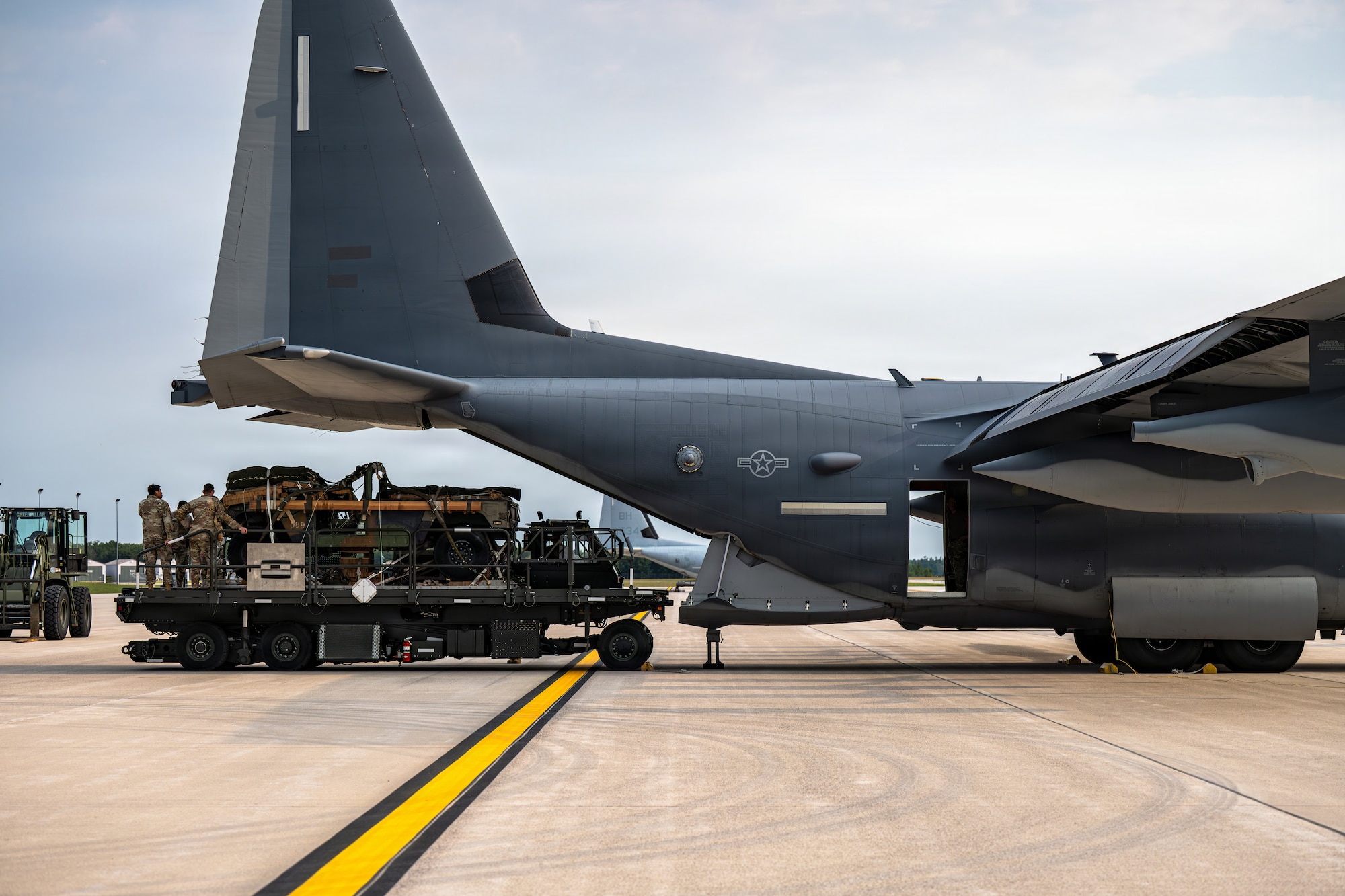 U.S. Soldiers and Airmen load a Humvee onto an MC-130J Commando II assigned to the 1st Special Operations Wing at Alpena Combat Readiness Training Center, Michigan, Aug. 9, 2026, during Northern Strike 26-2. The exercise provided a realistic environment for aircrews to train and certify on airdrop procedures and for ground forces to practice expeditionary loading techniques. (U.S. Air Force photo by Senior Airman Raul Mercado)