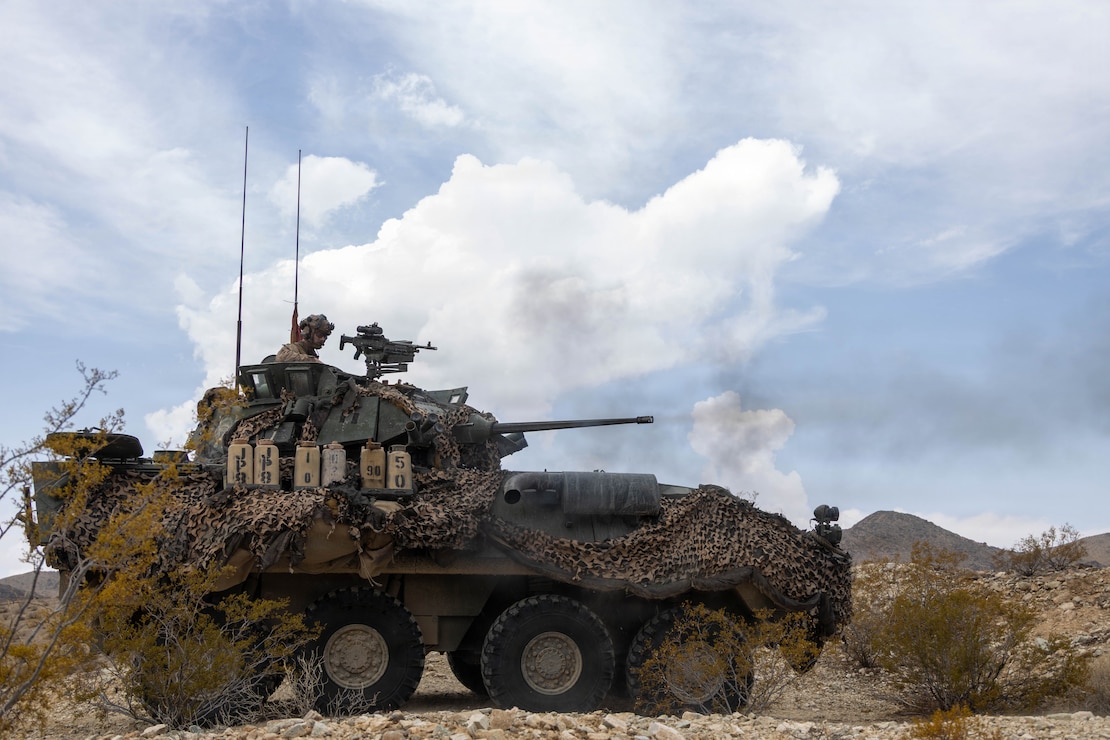 A U.S. Marine with Bravo Company, 3rd Light Armored Reconnaissance Battalion, 1st Marine Division, operates a light armored vehicle during a company supported bilateral defense, executing combined-arms dilemmas against dismounted enemy forces as part of Marine Air-Ground Task Force Distributed Maneuver Exercise on Training Area Delta during Service Level Training Exercise 4-26 on Marine Corps Air Ground Combat Center, Twentynine Palms, California, Aug. 11, 2026. SLTE 4-26 is designed to be a challenging, realistic training environment that produces combat-ready forces capable of operating as an integrated Marine Air-Ground Task Force across all domains of military operations. (U.S. Marine Corps photo by Cpl. Isaac Llanez Delgado)