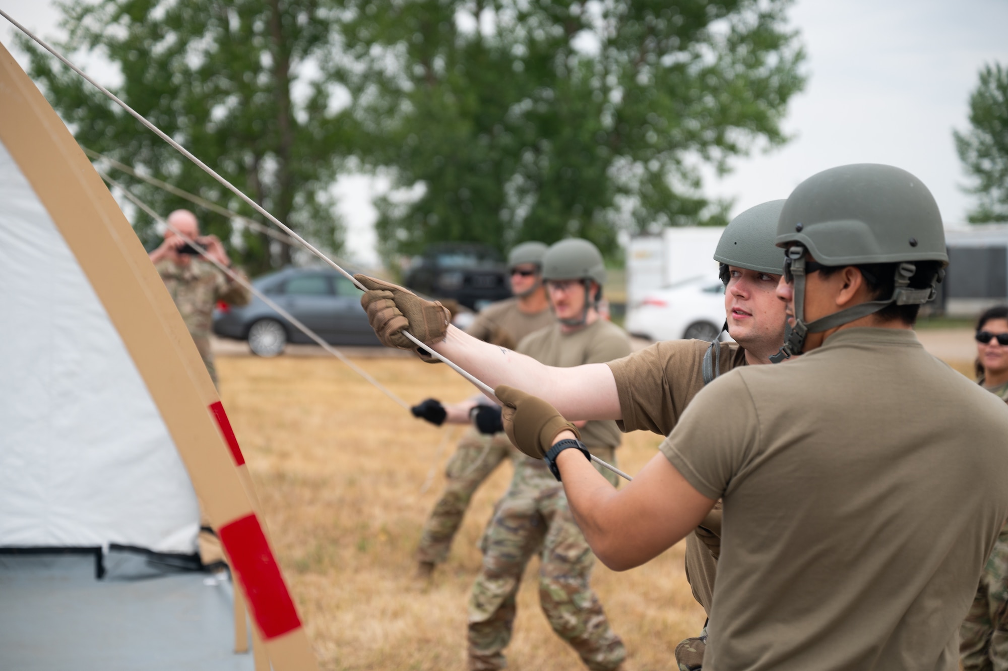 5th Comptroller Squadron Airmen raise a tent.