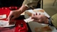 An Airman counts foreign currency by hand.