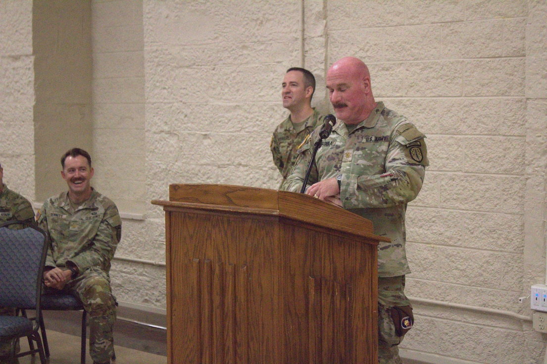 Maj. Thomas Kadela, team leader for medical advisor team (MEDAT) 6630, 6th Battalion, 54th Security Force Assistance Brigade, Illinois Army National Guard, tells a joke during his speech at the welcome home ceremony