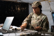An Airman counts physical cash.