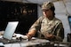 An Airman counts physical cash.