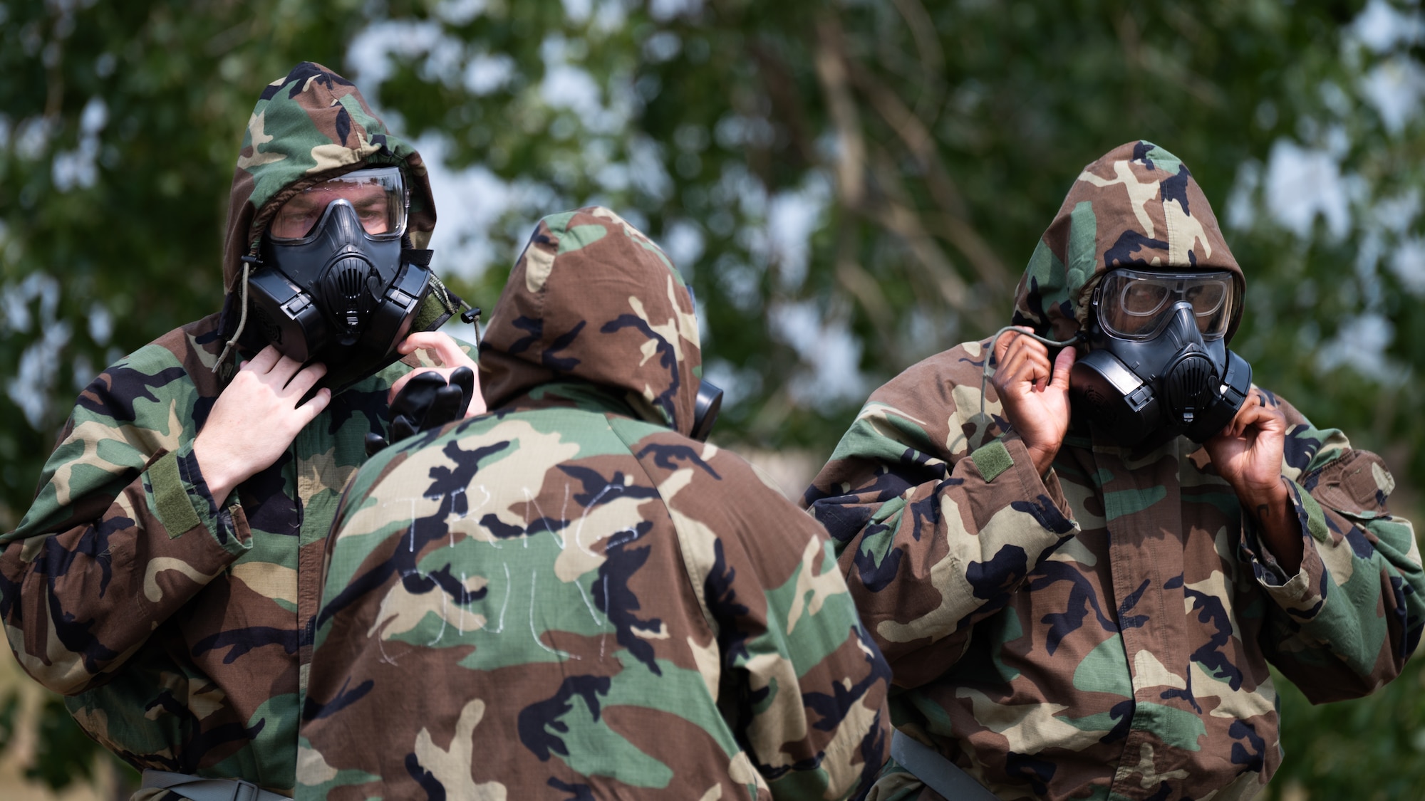 Airmen put on Mission Oriented Protective Posture gear.