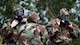 Airmen put on Mission Oriented Protective Posture gear.