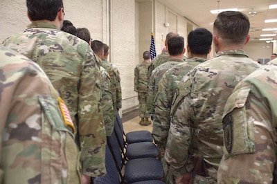 Soldiers of the 6th Battalion, 54th Security Force Assistance Brigade, Illinois Army National Guard, stand for the playing of the National Anthem
