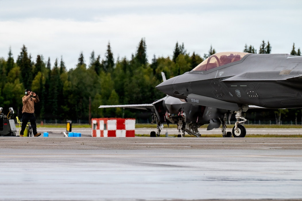 A U.S. Airman assigned to the 35th Fighter Wing at Misawa Air Base, Japan, marshals an F-35A Lightning II during RED FLAG-Alaska 26-3 at Eielson Air Force Base, Alaska, Aug. 18, 2026.