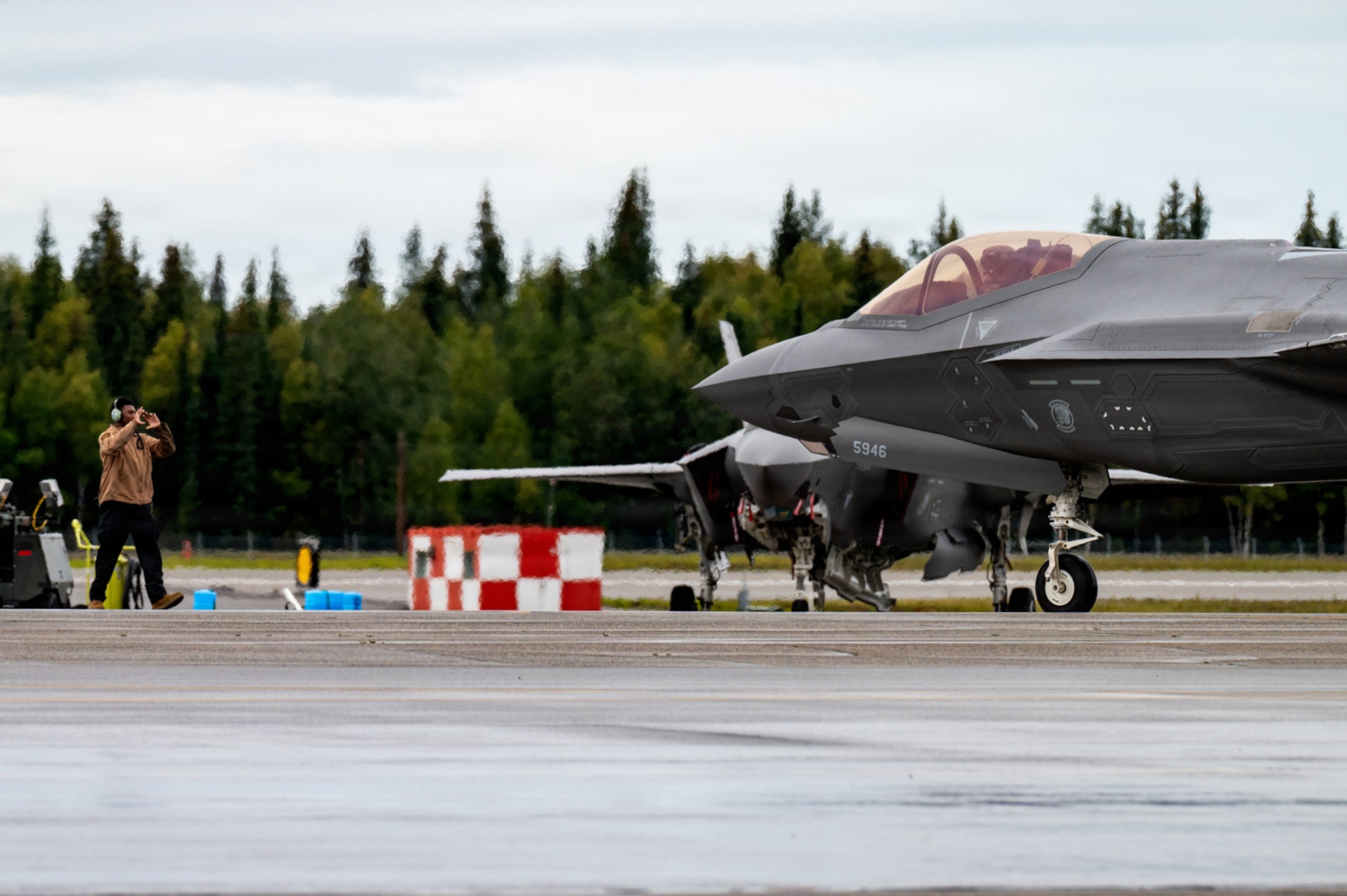 A U.S. Airman assigned to the 35th Fighter Wing at Misawa Air Base, Japan, marshals an F-35A Lightning II during RED FLAG-Alaska 26-3 at Eielson Air Force Base, Alaska, Aug. 18, 2026.