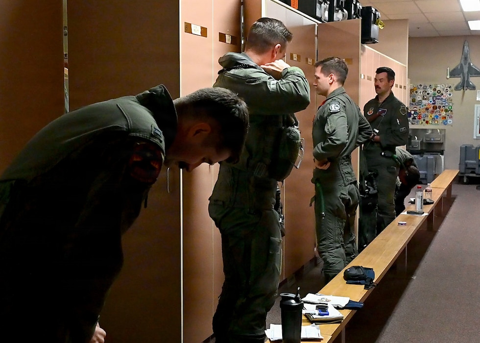 U.S. Air Force F-35A Lighting II pilots assigned to the 13th Fighter Squadron at Misawa Air Base, Japan, don their gear prior to a flight during RED FLAG-Alaska 26-3 at Eielson Air Force Base, Alaska, Aug. 18, 2026.