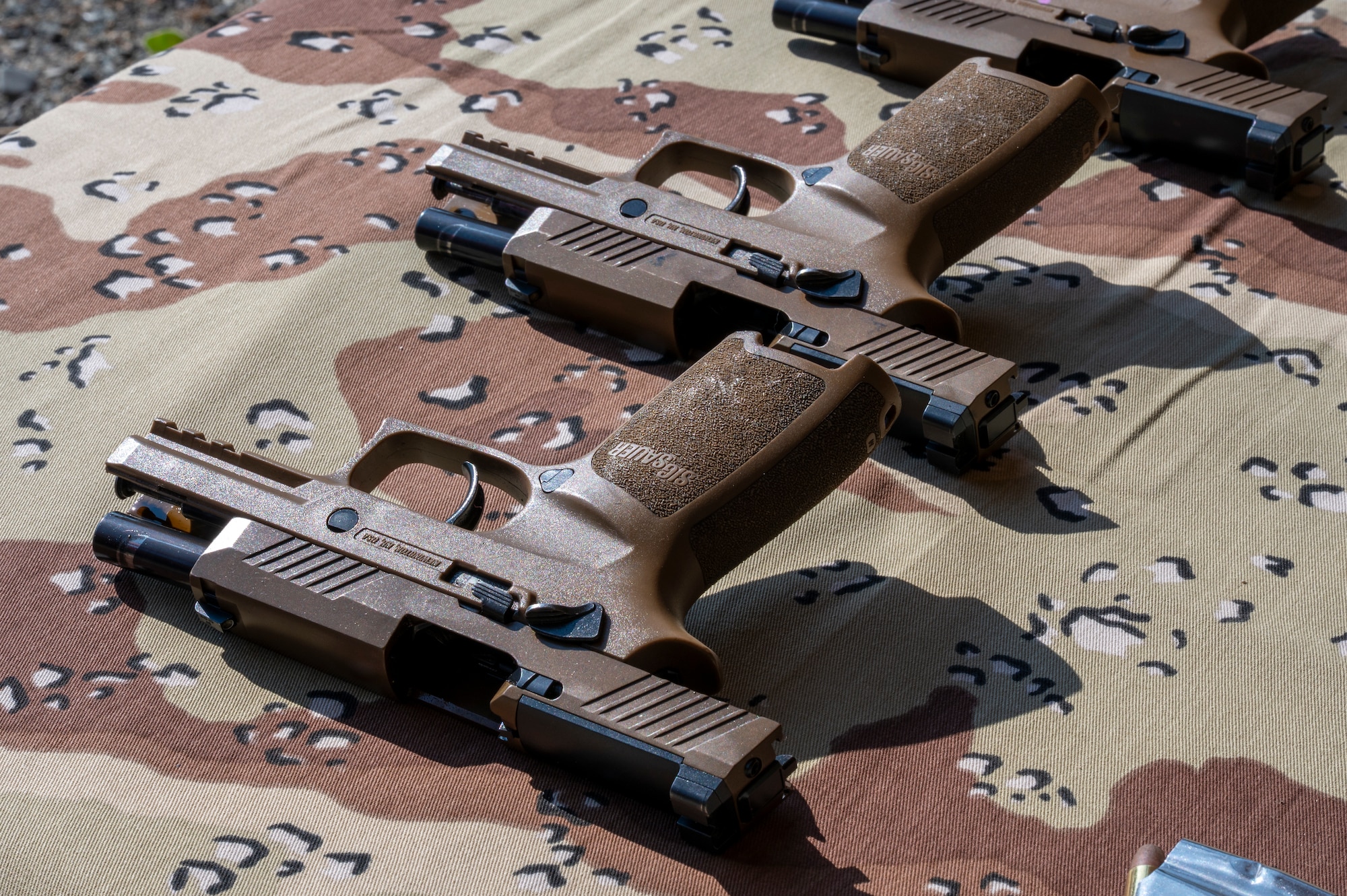 Unloaded weapons rest on a table.
