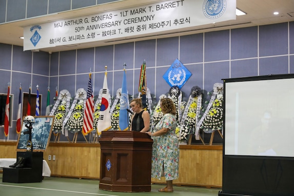Family members of Maj. Arthur G. Bonifas deliver a speech during the 50th commemoration ceremony for Maj. Bonifas and 1st Lt. Mark T. Barrett at Camp Bonifas on Aug. 18, 2026. Photographs of Bonifas are shown on a screen to the right as the event honors the two U.S. Army officers killed in the 1976 “axe murder incident” in the Korean Demilitarized Zone.