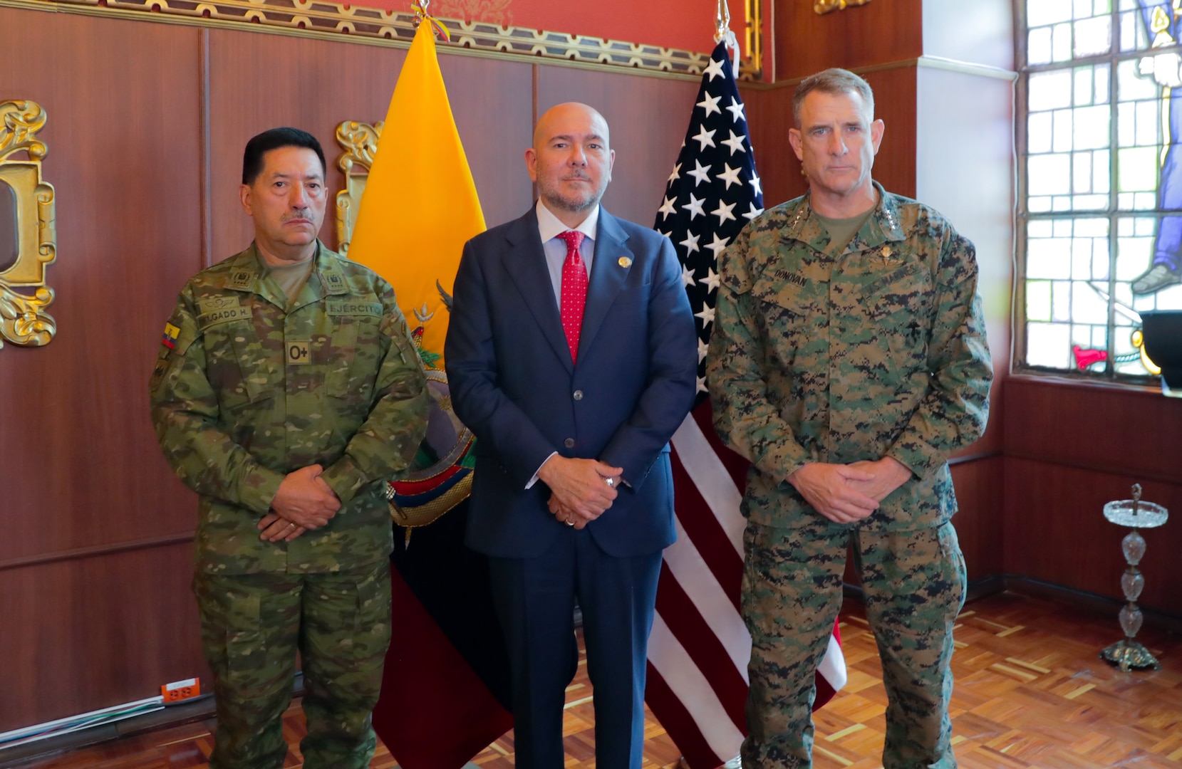 A U.S. Marine Corps General, right, poses for a photo with Ecuador's Minister of Defense, center, and Chief of Defense, left.
