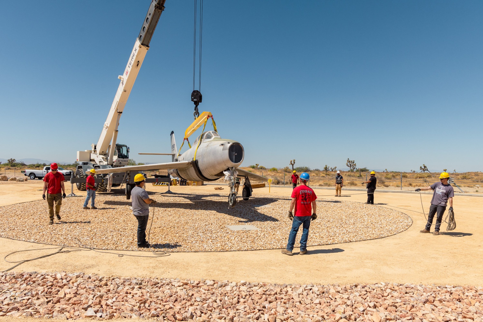 Members of the 412th Civil Engineer Squadron and the Crashed, Damaged, and Disabled Aircraft Recovery team transported the F-84F Thunderstreak tail number 51-9350 to the south gate at Edwards Air Force Base, California, Aug. 14. The 412th Security Forces Squadron diverted traffic to allow the aircraft to be moved from the Flight Test Museum to its new home as a permanent gate guard. (U.S. Air Force photo by Brandon Hernandez)