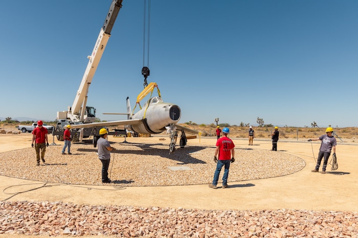 Members of the 412th Civil Engineer Squadron and the Crashed, Damaged, and Disabled Aircraft Recovery team transported the F-84F Thunderstreak tail number 51-9350 to the south gate at Edwards Air Force Base, California, Aug. 14. The 412th Security Forces Squadron diverted traffic to allow the aircraft to be moved from the Flight Test Museum to its new home as a permanent gate guard. (U.S. Air Force photo by Brandon Hernandez)