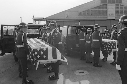 The caskets of Army Maj. Arthur G. Bonifas and Army 1st Lt. Mark T. Barrett are placed in vans by an Army military police honor guard at Yokota Air Base, Japan, in August 1976. The soldiers were killed by a group of North Korean guards during an incident at the joint security area in the Korean Demilitarized Zone.