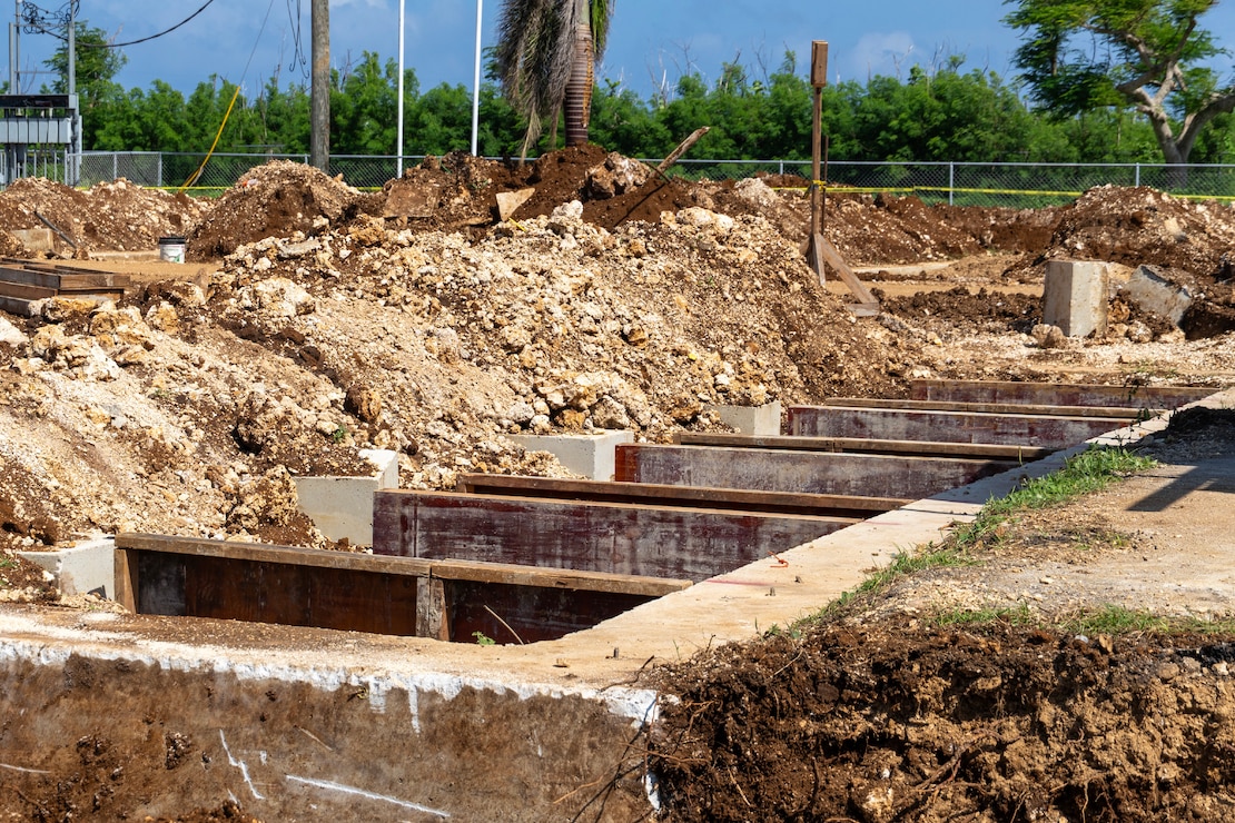 Wood panels are placed inside the perimeter of a concrete foundation.