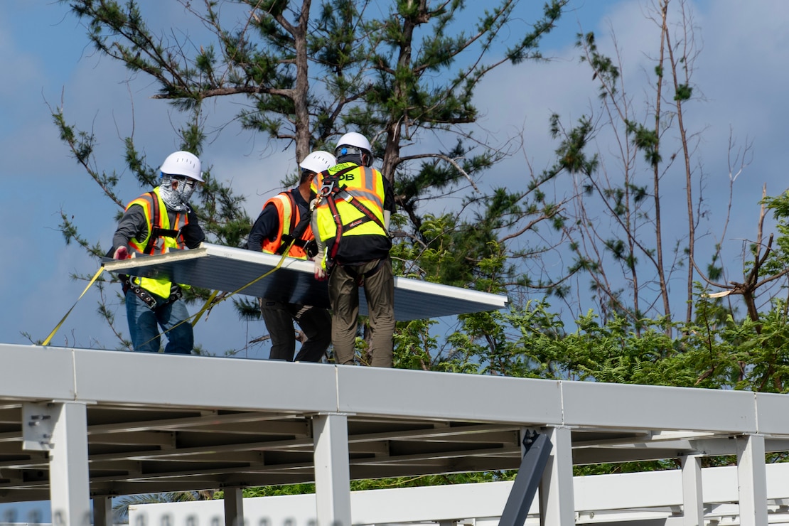 Construction workers assemble a steel building structure.