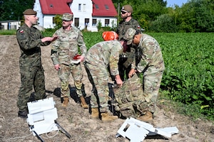 Polish and U.S. Army soldiers recover a high-altitude balloon payload in Latowice, Poland, Jul. 27, 2026. The combined recovery operation strengthened interoperability and demonstrated the allies’ ability to coordinate high-altitude operations across the European theater. (U.S. Army photo by Sgt. 1st Class Rajheem Dixon)