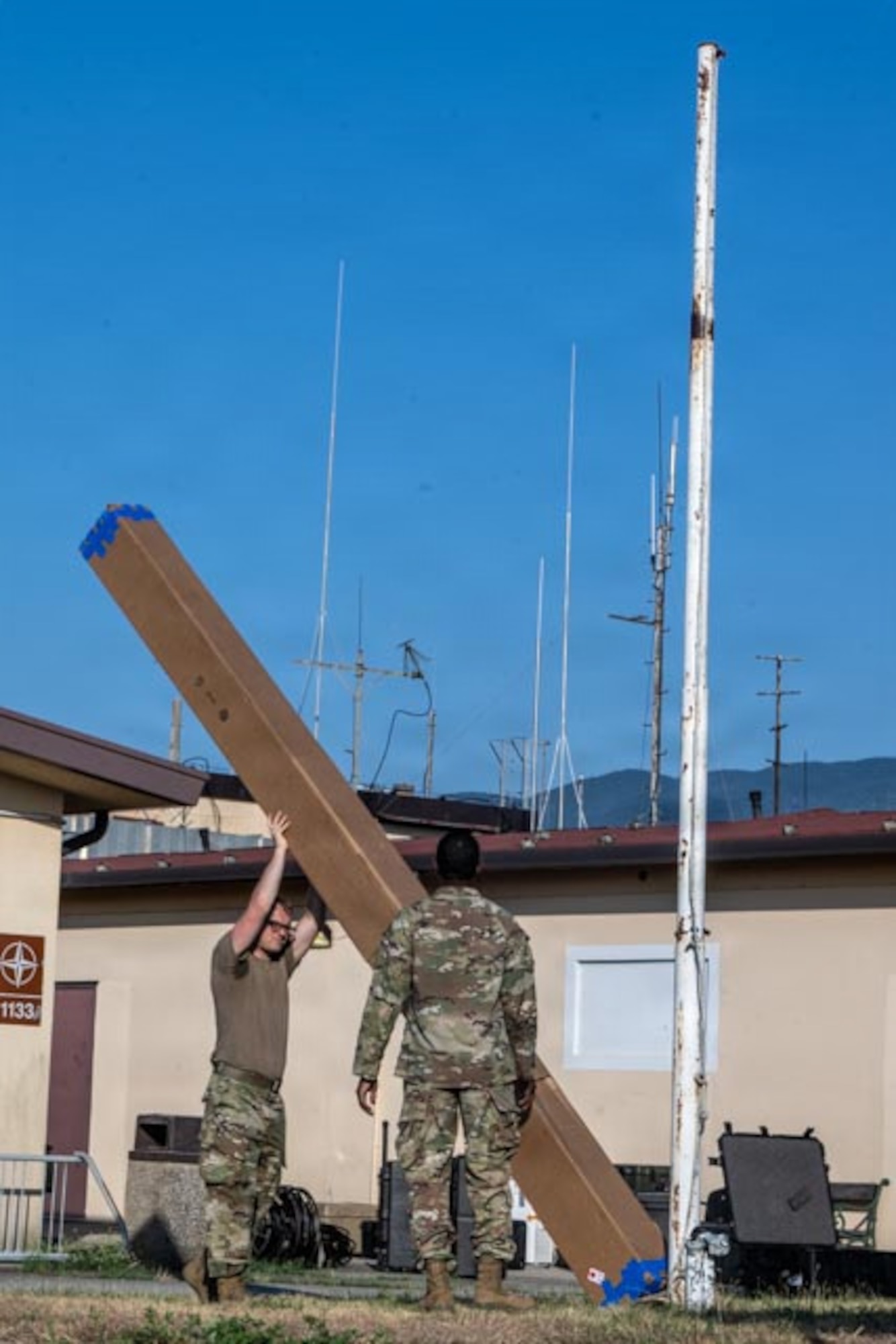 Airmen measure a communication tower.