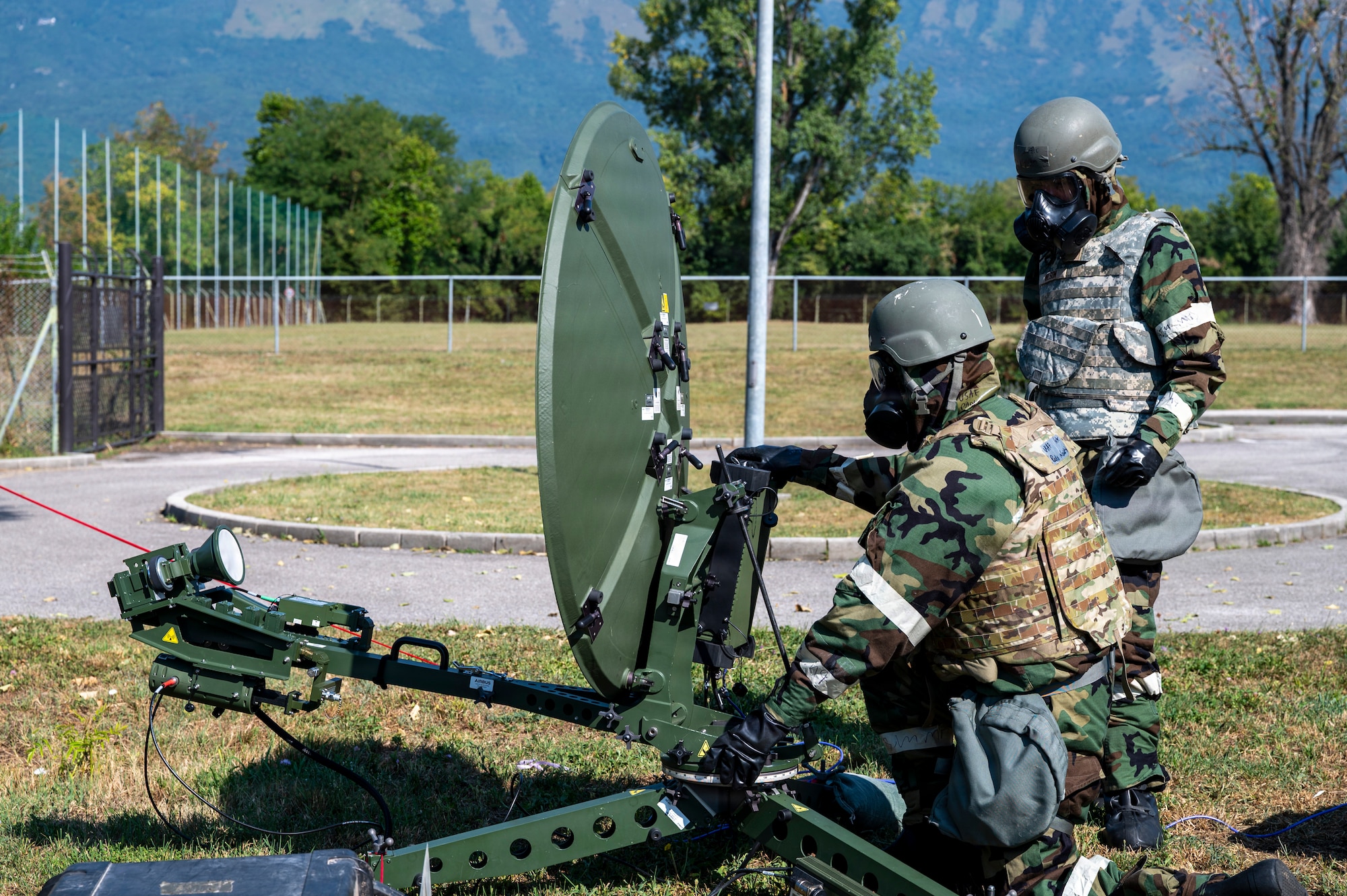 Airmen check on satellite dishes.