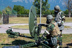 Airmen check on satellite dishes.