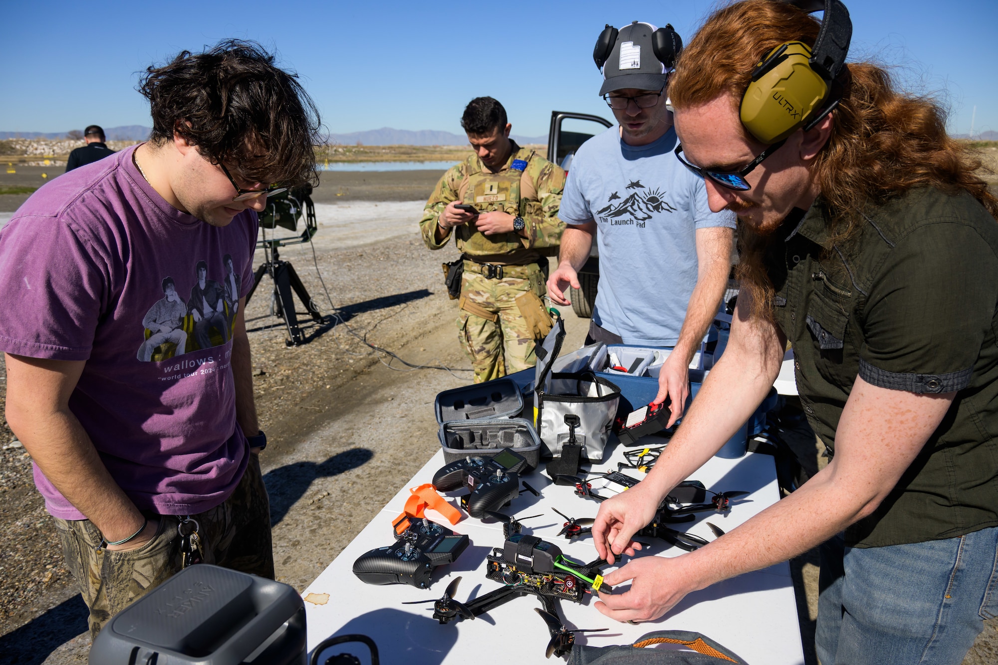 Left to Right, Charbel Salloum, Steve Turner and Mitch Wheat, 309th Software Engineering Group's Black Knights team, prepare drones for testing at a Box Elder County range, March 18, 2026. The team builds custom, Blue-listed drones for base units. (U.S. Air Force photo by R. Nial Bradshaw)