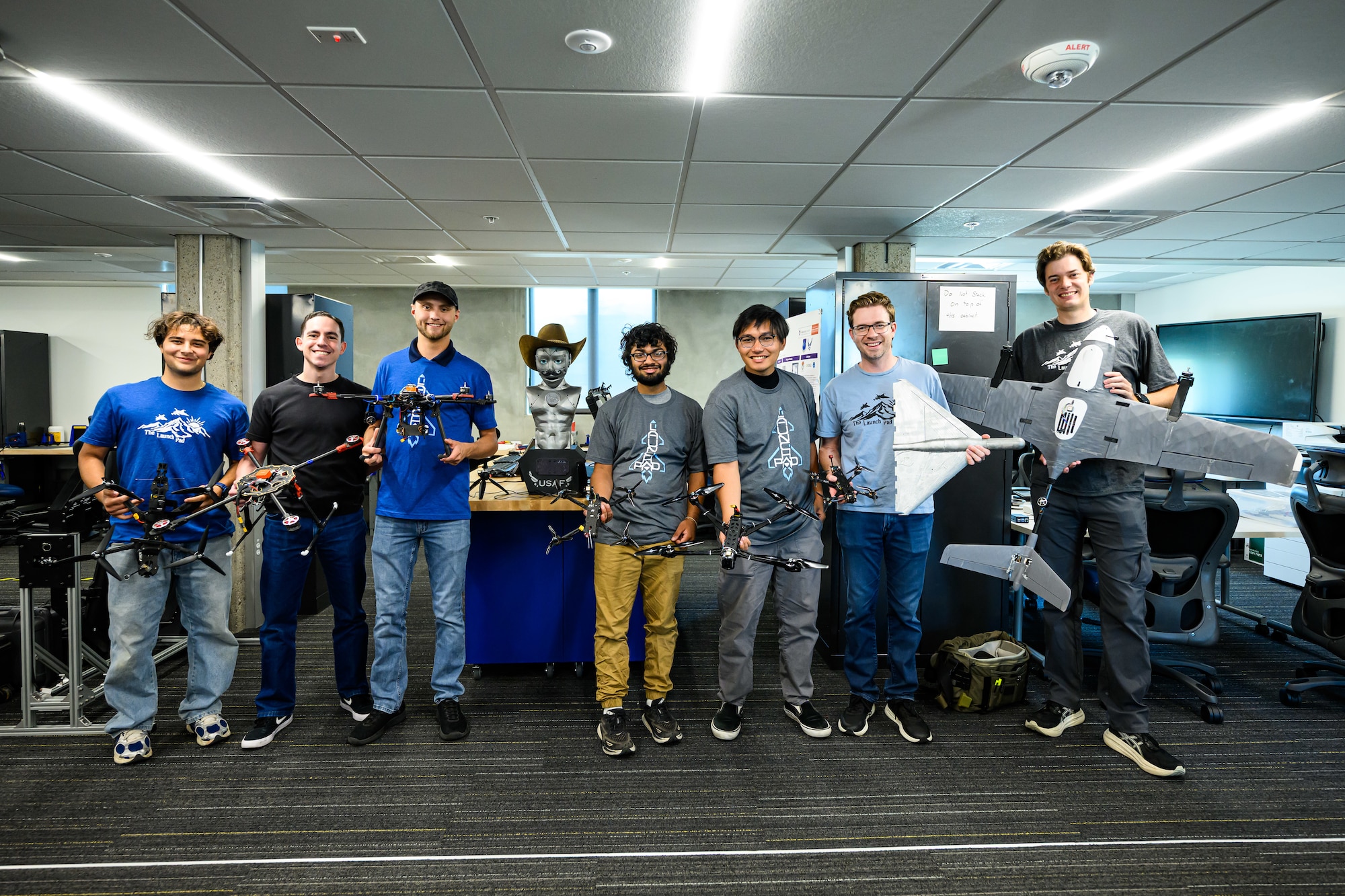 Hill's Black Knights team pose with a variety of drones they have built for base units. Operating out of the 309th Software Engineering Group's "Launch Pad," the team builds Blue-listed drones and provides flight training for its customers. (U.S. Air Force photo by R. Nial Bradshaw)