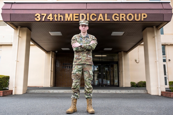 U.S. Air Force Capt. Zachary Hicks, a family medicine physician, poses for a photo outside the 374 HCOS.
