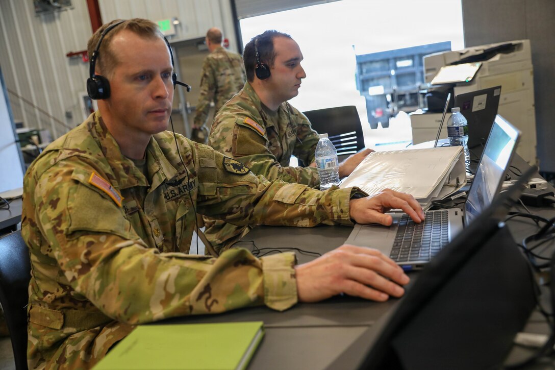 U.S. Army Maj. Miles Miller, the project officer with Task Force 46, looks over his logistics plans during Vibrant Response 2026 at Camp Atterbury, Indiana, Apr. 24, 2026.