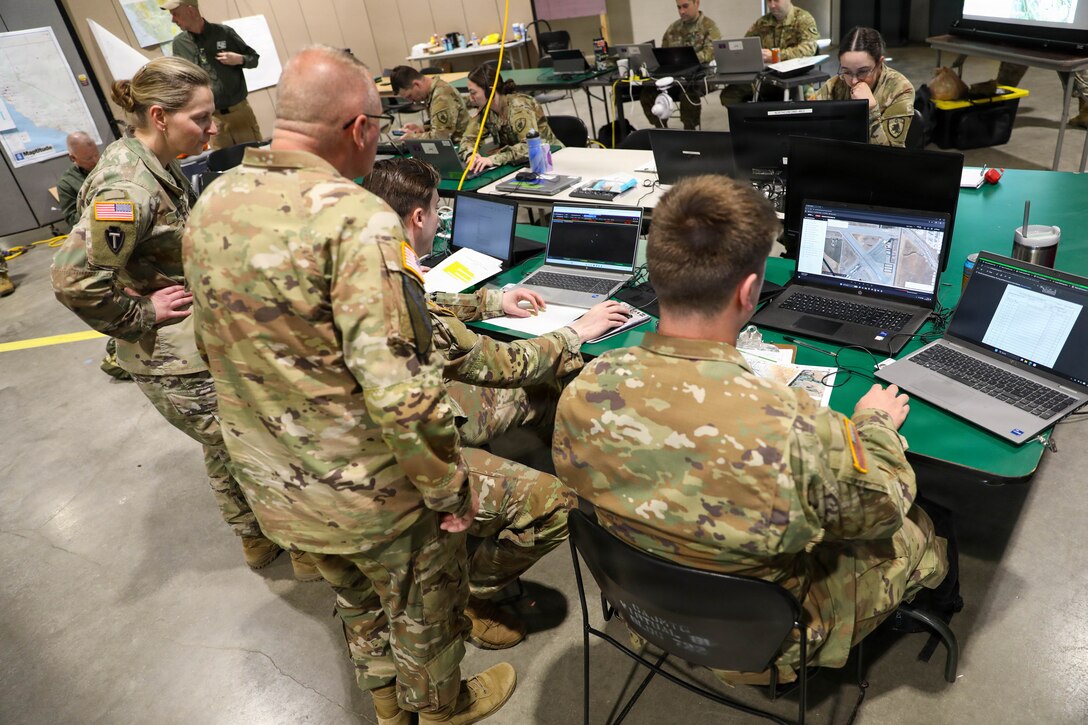 U.S. Army Staff Sgt. John Mattas, the battle non-commissioned officer with the 63rd Aviation Brigade, explains the battle space to Brig. Gen. Joseph D. Lear, the Kentucky National Guard's land component commander, during Vibrant Response 2026 at Camp Atterbury, Indiana, Apr. 24, 2026.