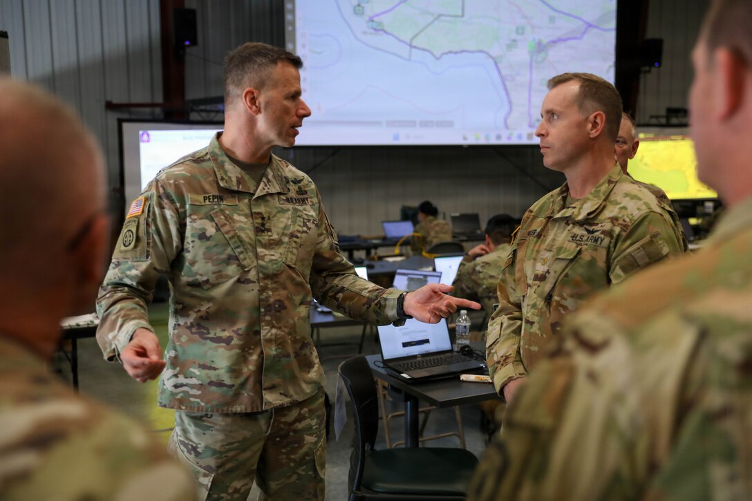 U.S. Army Lt. Gen. Allan M. Pepin, United States Army North’s commanding general, speaks to Maj. Miles Miller, the project officer with Task Force 46, and other distinguished leaders from the 63rd Theater Aviation Brigade during Vibrant Response 2026 at Camp Atterbury, Indiana, Apr. 24, 2026.