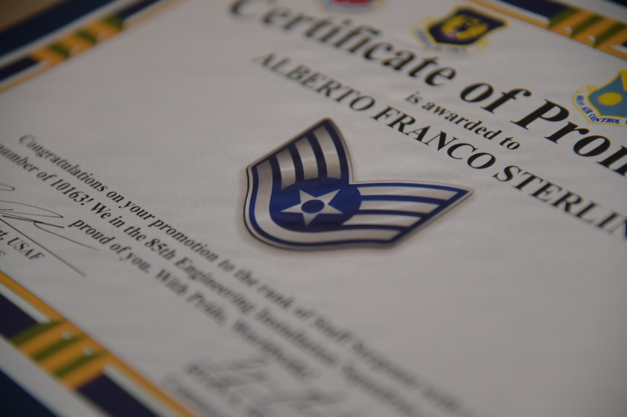 A certificate with Staff Sergeant stripes is on display.