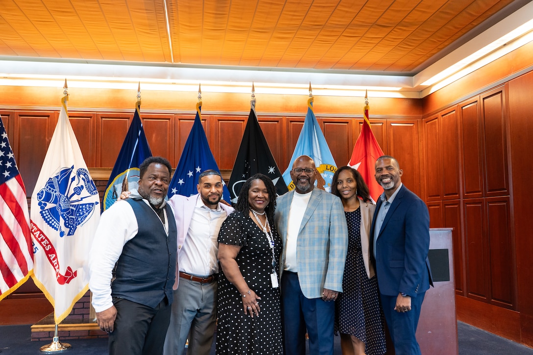 Six people pose for a photo.